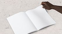 Hand of a Black person turning the page on a book with blank white pages_photo from Unsplash