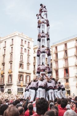Tower of people climbing onto each other's shoulders